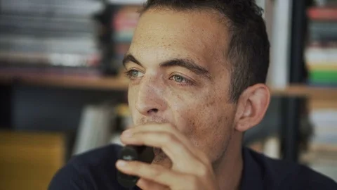 Handsome man smoking e-cigarette at his leisure time Stock Footage 80934896