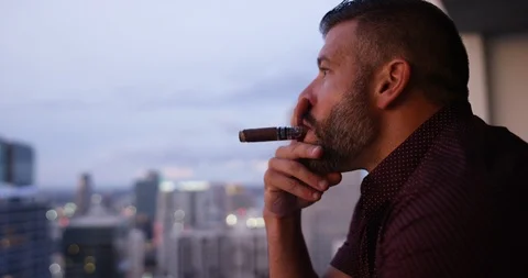Handsome man smoking while having whisky Stock Footage 116348878