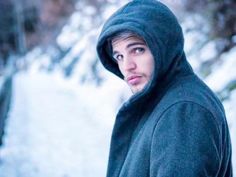 Handsome man in snow posing for camera Stock Photos