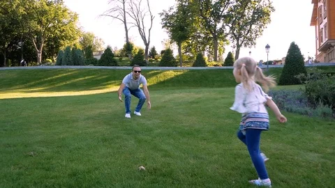 Handsome man is spending time with his little charming daughter outdoors. Dad Video stock 99290434