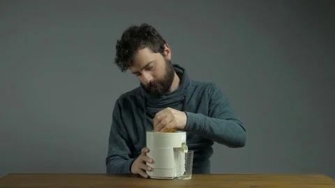 Handsome Man with Squeezer Squeezing Orange Juice Isolated Grey Background Stock Footage 76521772
