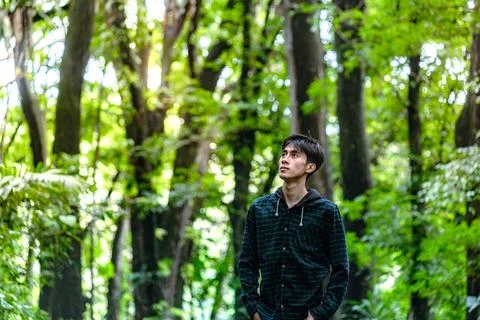 Handsome man standing alone while looking around. Beautiful dramatic deep f.. Stock Photos