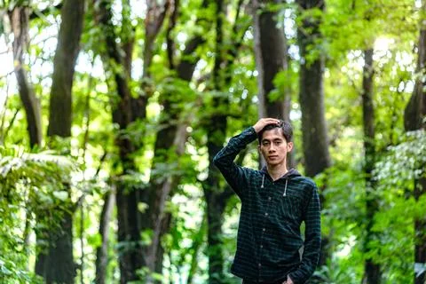 Handsome man standing alone while looking around. Beautiful dramatic deep f.. Stock Photos