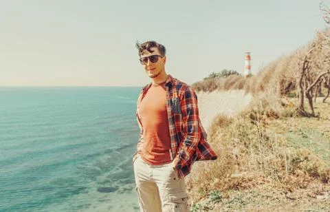 Handsome man standing on beach Stock Photos