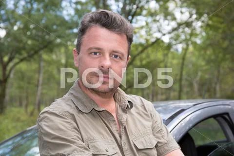 Handsome man standing near the grey car Stock Photos