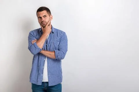 Handsome man standing with thinking look.- Image Stock Photos