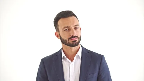 The handsome man standing on the white wall background. slow motion Stock Footage 104536147