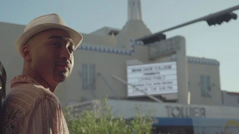 Handsome man stands in front of Tower Theater on Calle Ocho in Little Havana, Stock-Footage 126054364