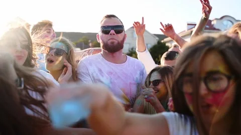 Handsome man with strong face threading way through crowd, starts shouting. Guy Stock Footage 177301554