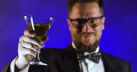 Handsome man in suit drinking champagne on black background Stock Footage 130817215