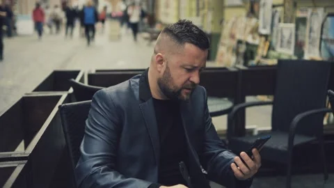 Handsome Man in Suit is smiling Charmingly while browsing Internet on his Phone. Stock Footage 172504707