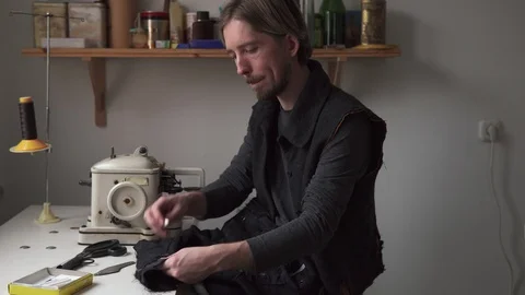 Handsome man tailor working in sewing workshop Stock Footage 101368799