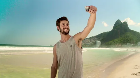 Handsome man taking a selfie on smartphone at Ipanema beach Stock Footage 59376549