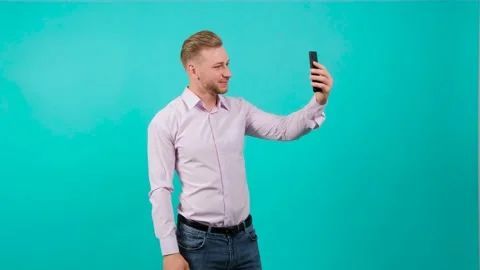 Handsome man talking on video call and waving hand making hi gesture. Stock Footage 143022652