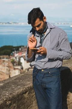 Handsome man texting in a vacation context Stock Photos