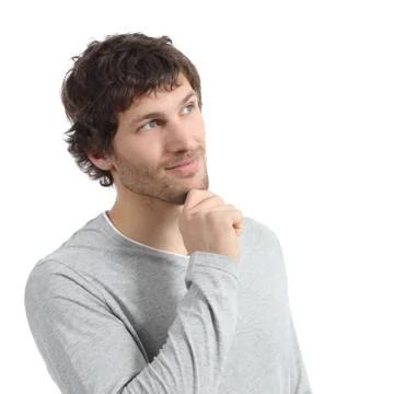 Handsome man thinking and looking above with a hand on chin Stock Photos