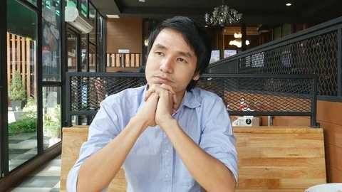 Handsome man thinking and waiting for woman in café Video stock 77268679