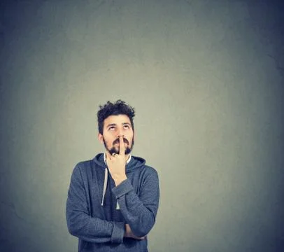 Handsome man thinking contemplating on idea looking up Stock Photos