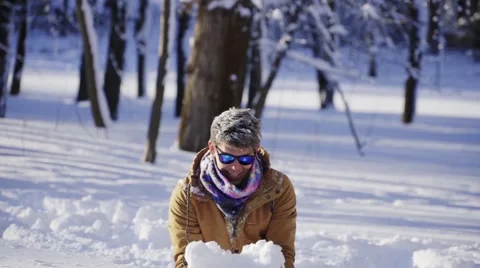Handsome man throws snow up in winter Stock Footage 66782039