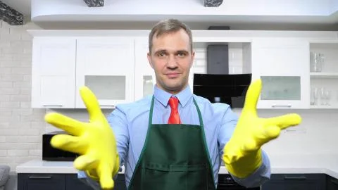 Handsome man in tie and apron wearing rubber gloves Stock Illustration