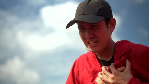Handsome man tired during jogging and heart attack at sport stadium. Young asian Stock Footage 247428278