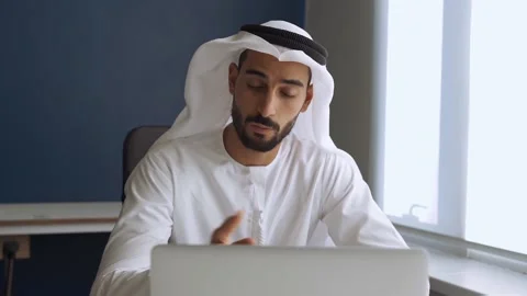 Handsome man with traditional clothes working in an office of Dubai Stock Footage 167856817