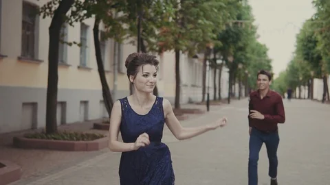Handsome man try catch up beautiful girlfriend. Man and woman having fun Video stock 91432072