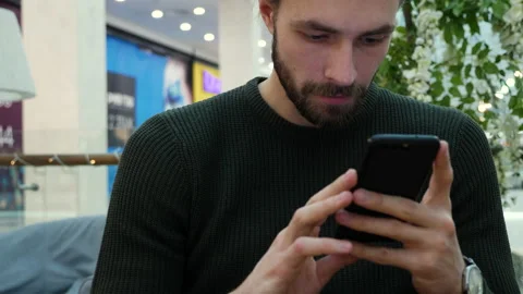 Handsome man typing on smartphone sms Stock Footage 140743257