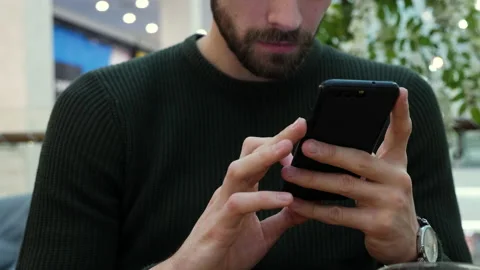 Handsome man typing on smartphone sms Stock Footage 140743321