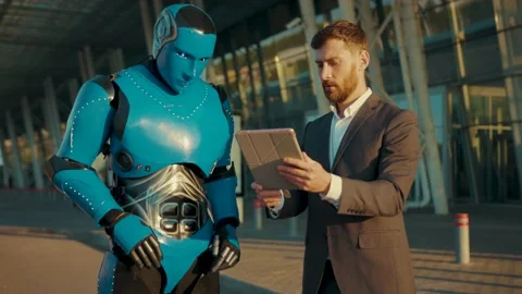 Handsome man use tablet computer talking with humanoid robot digital future in Video stock 133297489