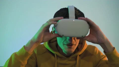 Handsome man use VR headset, listen music at virtual concert, dance in room with Stock Footage 225157569