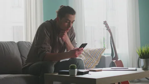 Handsome Man Uses Smartphone Stock Footage 156743617