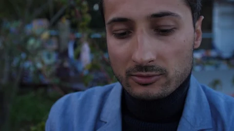 Handsome man uses tablet in the park Stock Footage 96578978