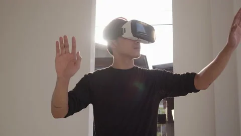 Handsome Man using 3D virtual reality headset Видео 157035045