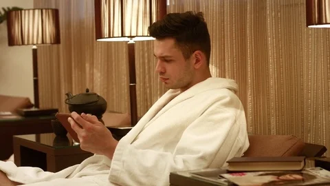 Handsome man using digital tablet at home Stock Footage 82297374