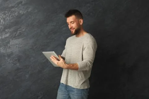 Handsome man using digital tablet in studio Photos