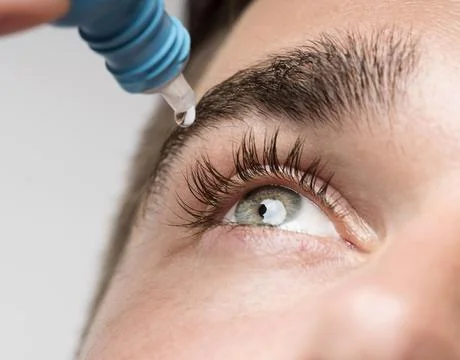 Handsome man using eye drops close up. High quality photo Stock Photos
