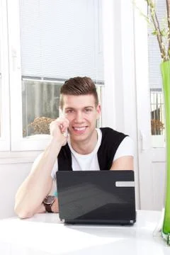 Handsome man using laptop and mobile Stock Photos
