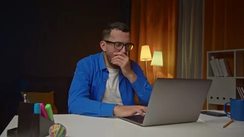 Handsome man Using laptop feel sleepy and tired and yawns from boring routine on Stock Footage 249521325