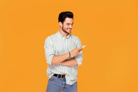 Handsome man using mobile phone. Stock Photos