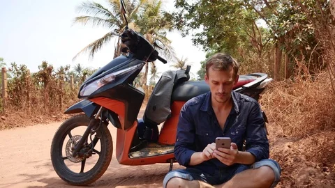 Handsome man using phone while traveling Stock Footage 121299402