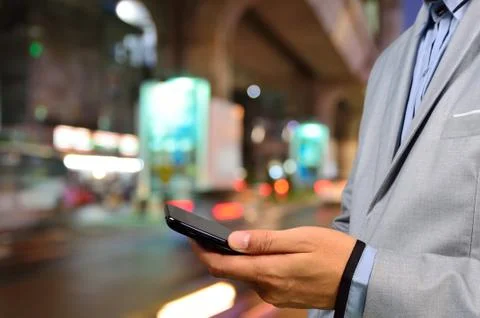 Handsome man using smart phone mobile in the city at night Stock Photos