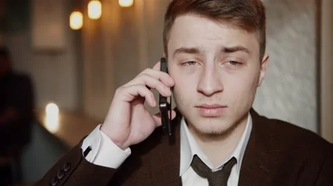 Handsome man using smartphone at cafe and smiling Stock Footage 57112410