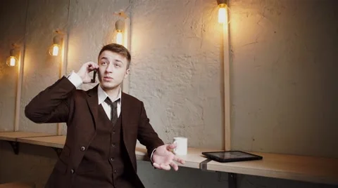 Handsome man using smartphone at cafe and smiling Stock Footage 57113384