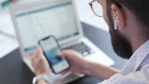 Handsome man using smartphone scrolling social network. Stock Footage 116329238