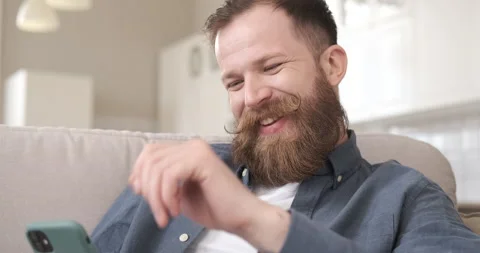 Handsome man using smartphone scrolling pictures in application. Stock Footage 155836580