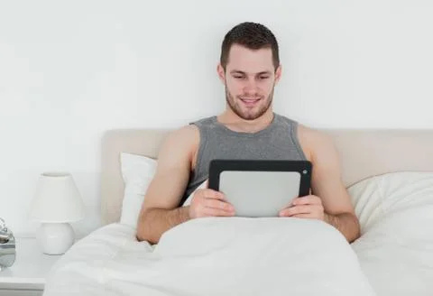 Handsome man using a tablet computer Stock Photos