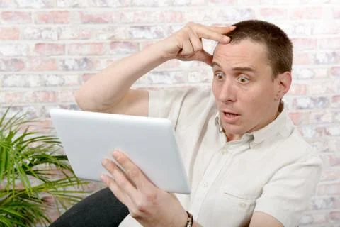 Handsome man using tablet computer Stock Photos