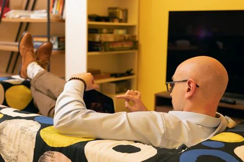 Handsome man using tablet computer while enjoying time for internet at home Stock Photos