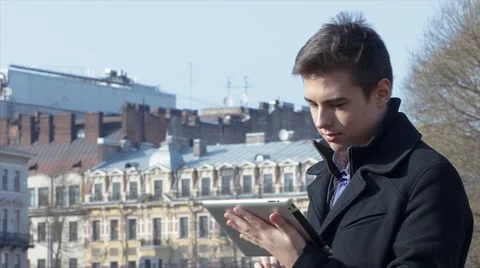 Handsome man using tablet outside Stock Footage 61865257